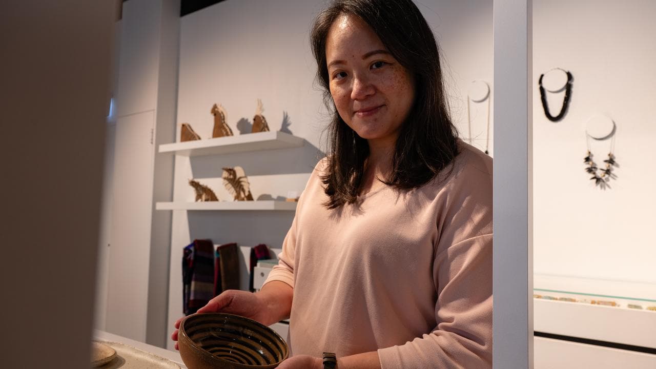 Artist Mavis Chan with her work