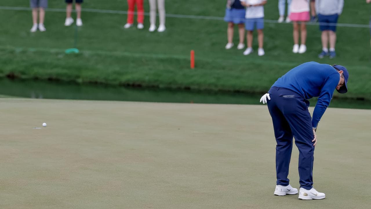 Rory McIlroy reacts to his missed putt