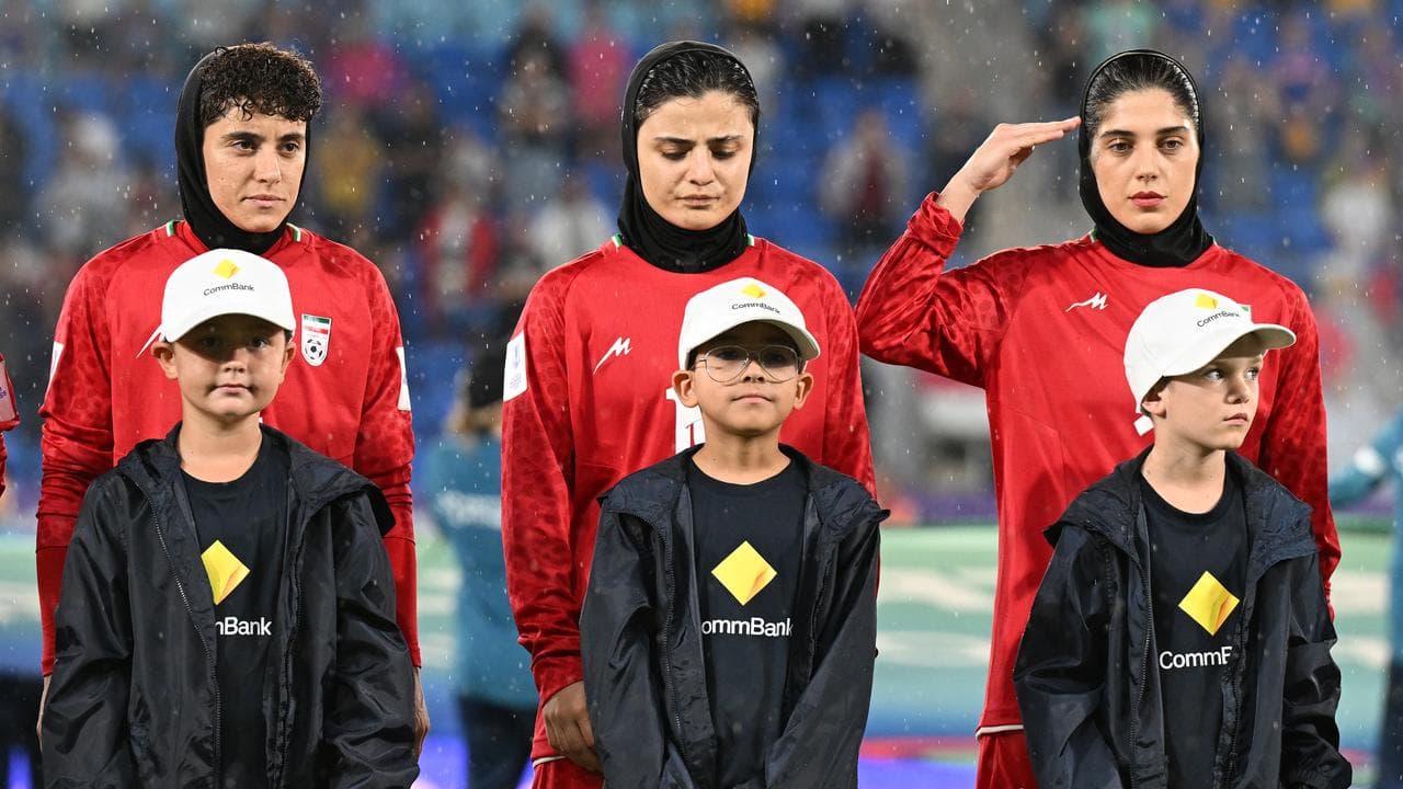 Iran players are seen during their national anthem