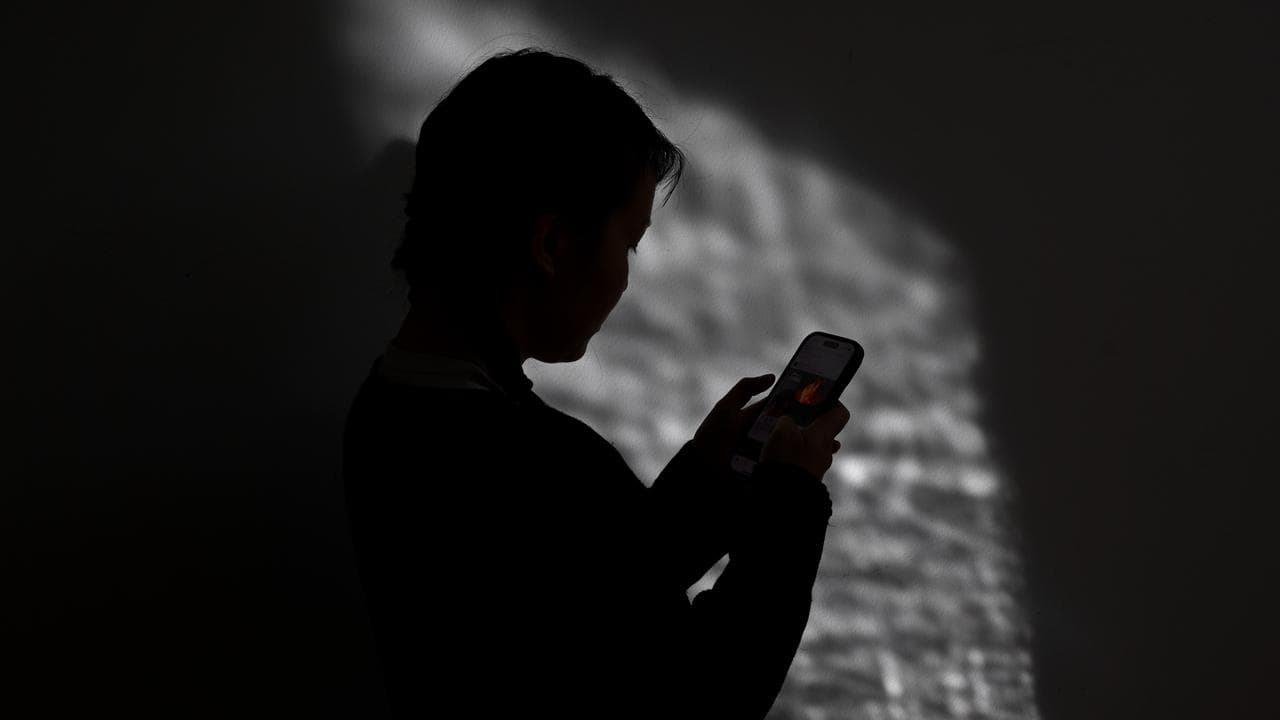 A young woman use a mobile phone (file image)