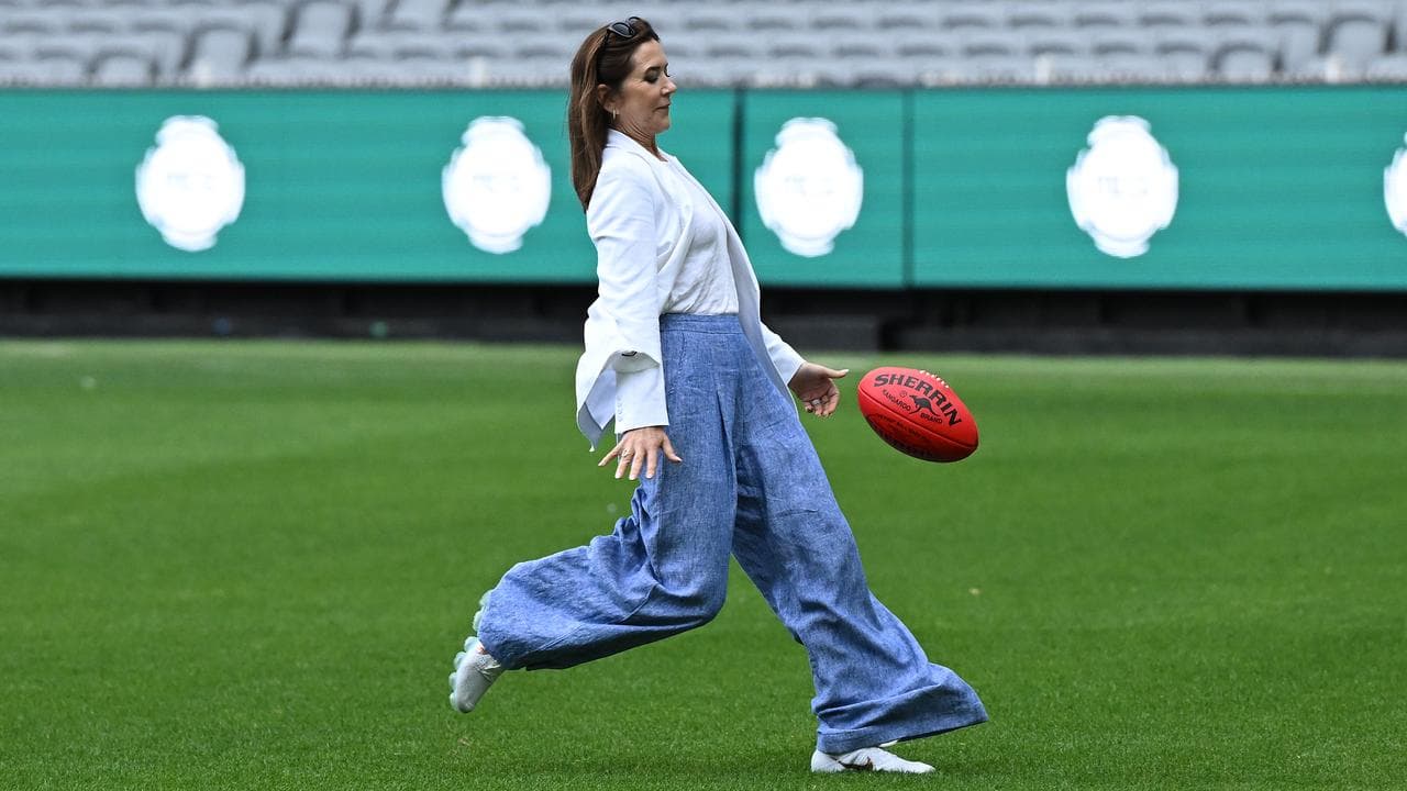 Denmark's Queen Mary kicks a football at the MCG