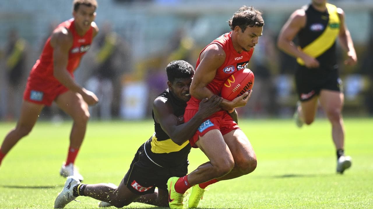 Maurice Rioli of Richmond tackles Daniel Rioli of the Suns