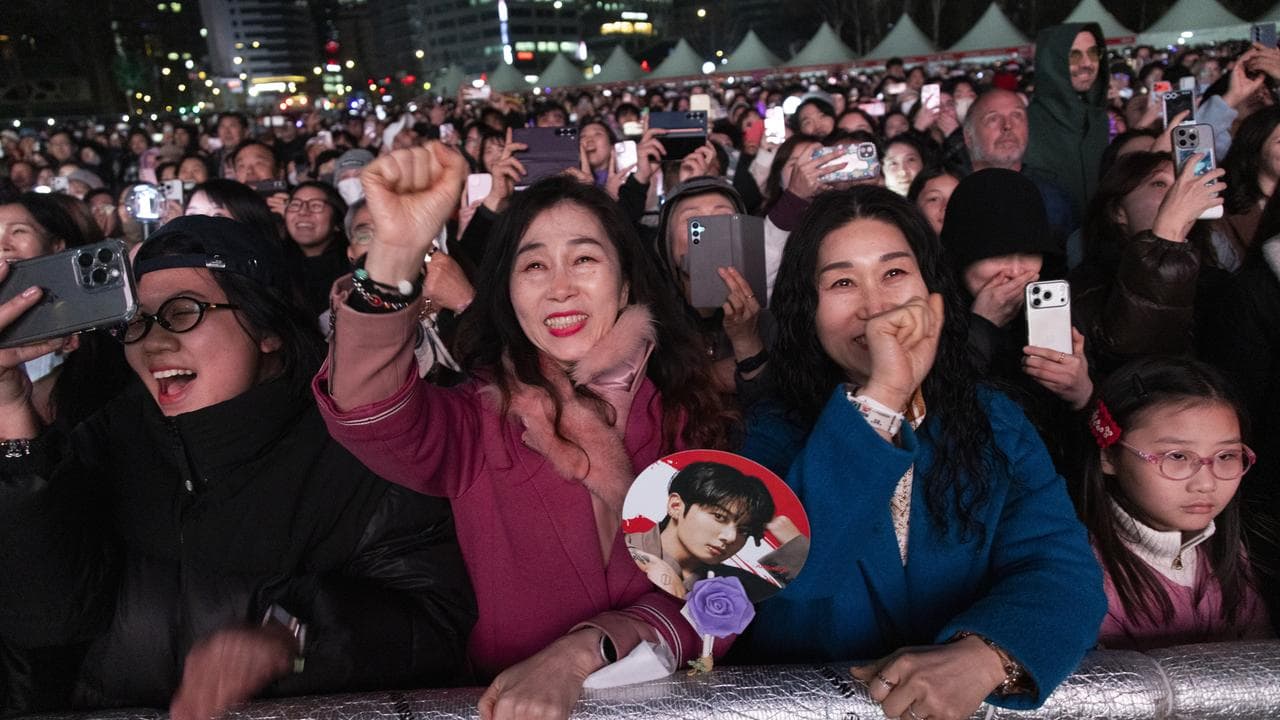 ans cheer as K-pop group BTS performs