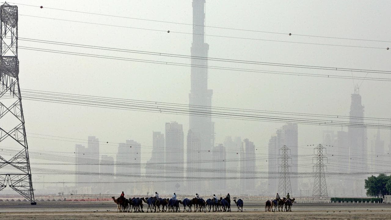 Electricity lines in front of the skyline in Dubai