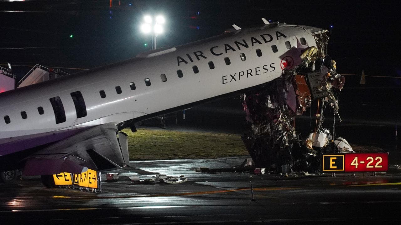 A crashed Air Canada Jet sits on the runway at LaGuardia Airport