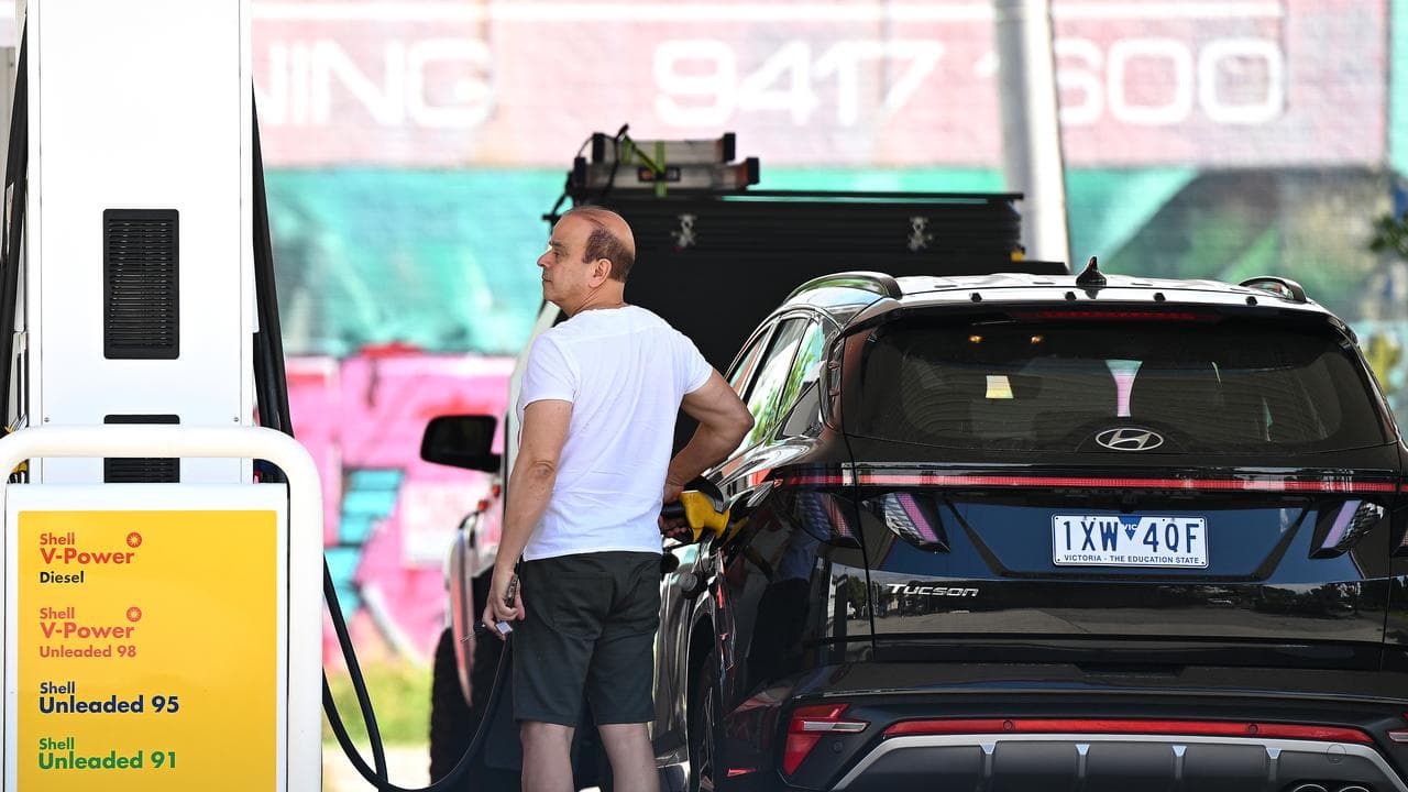 People fill up at a petrol station in Melbourne