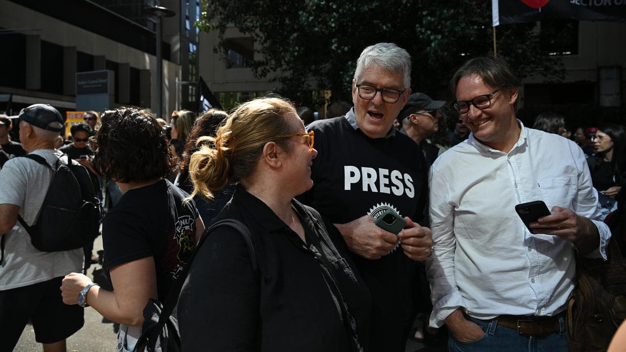 David Marr (centre) joins ABC staff as they walk off the job