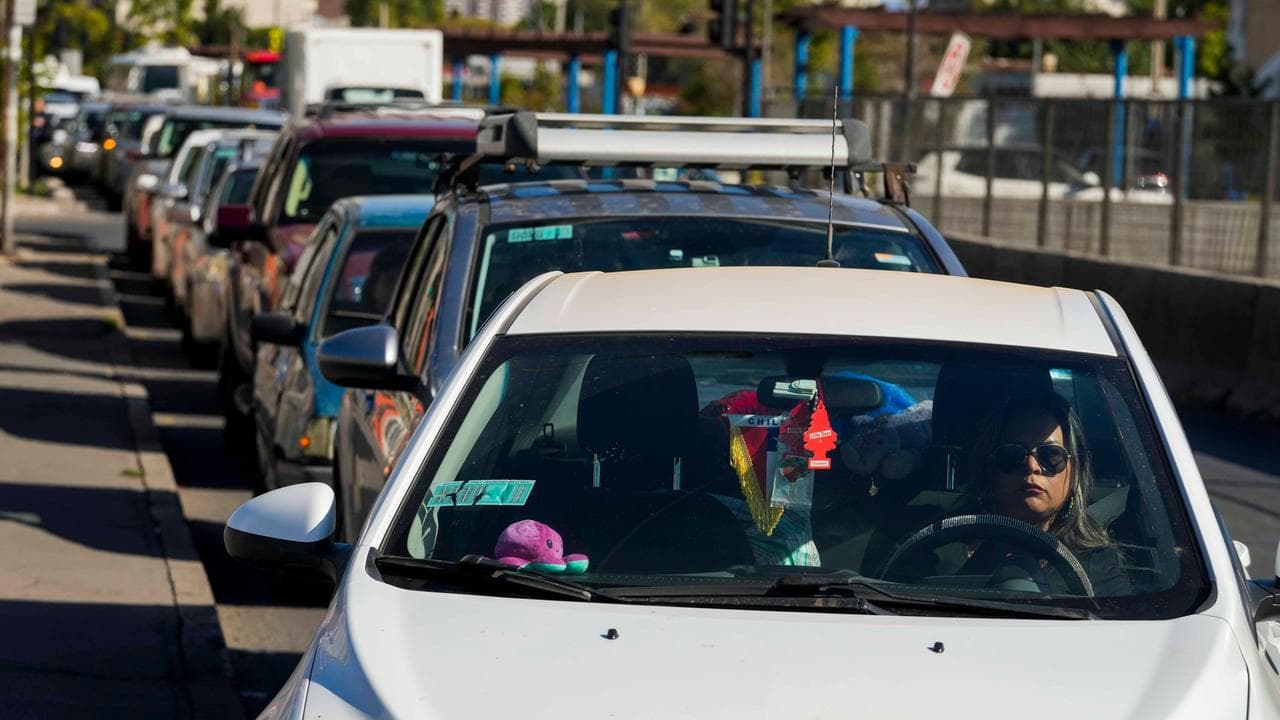 Drivers line up to fill their tanks with petrol in Santiago, Chile