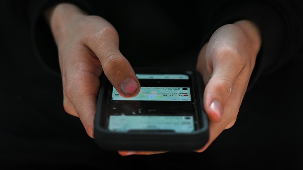 A person uses a mobile phone to access social media (file image)