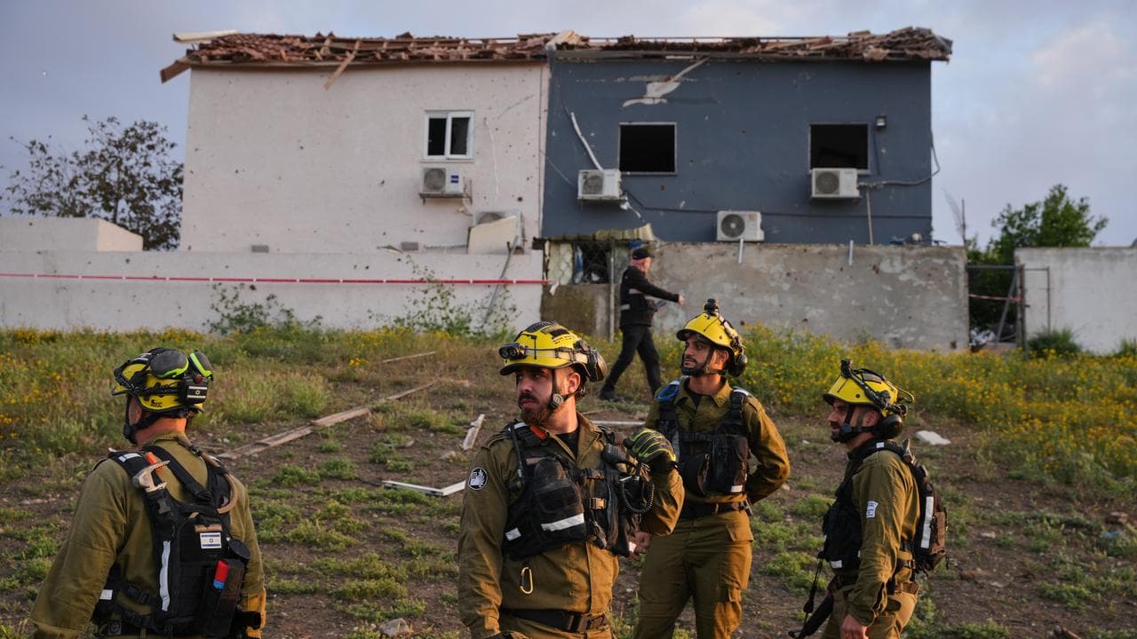 Israeli forces inspect an Iranian missile strike site