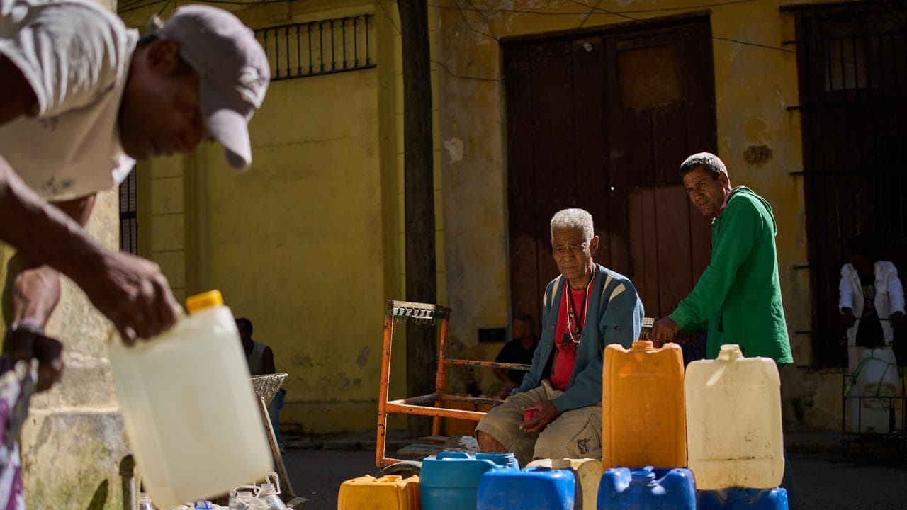 A man fill containers with potable water