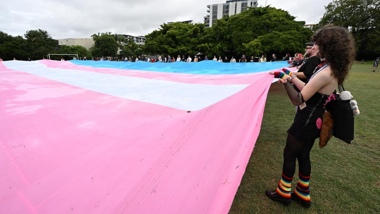 People unfurl the world’s largest trans flag