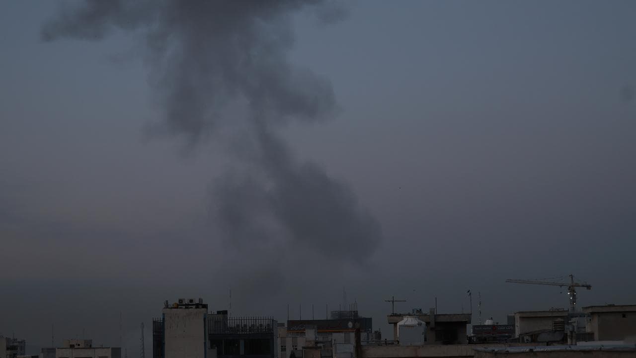 Smoke rises after an airstrike in central Tehran, Iran