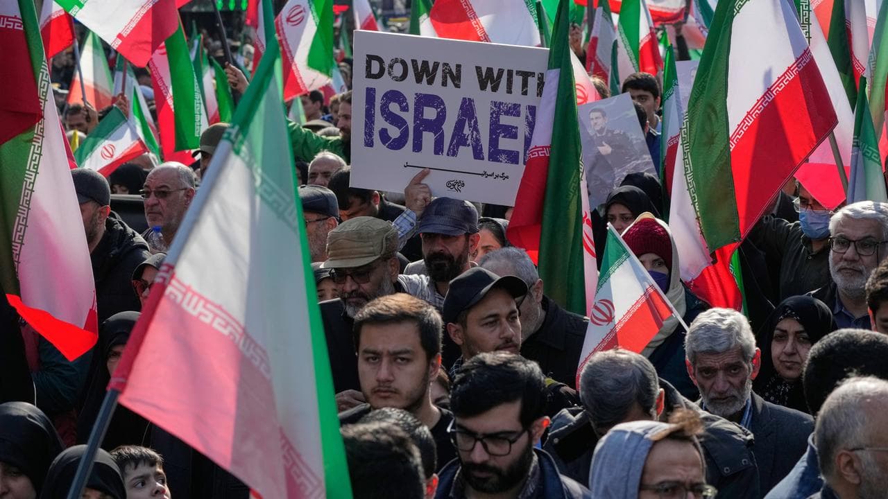 A man carries an anti-Israeli placard in Tehran, Iran