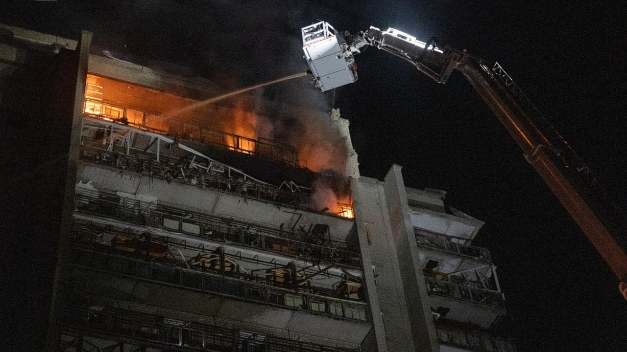 Rescue workers putting out a fire from a Russian strike