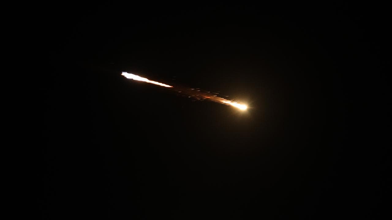 Light streaks from Iranian ballistic missiles over the West Bank