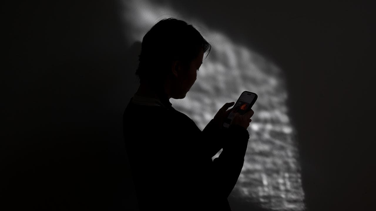 A person using a mobile phone (file image)