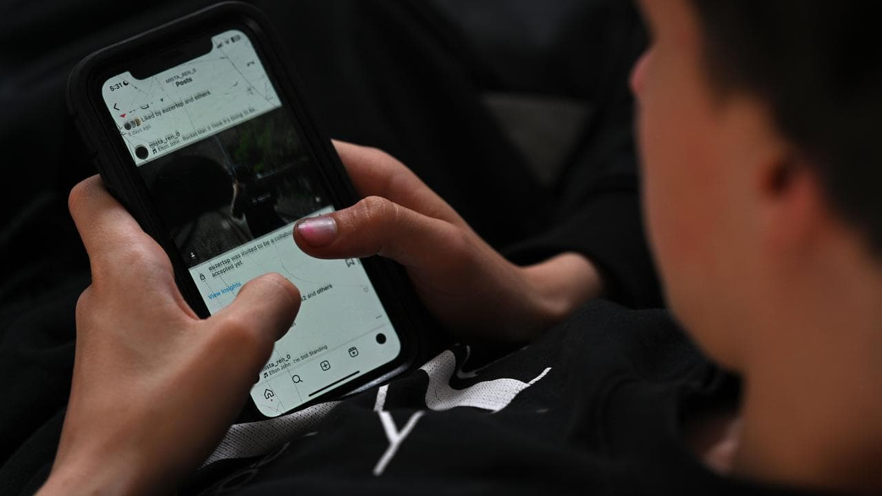 A teenager uses his mobile phone to access social media, Sydney