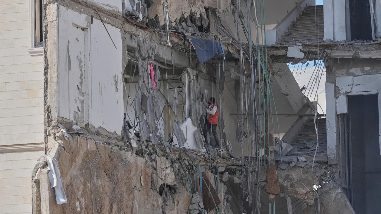 A rescuer checks a destroyed building hit in an Israeli airstrike