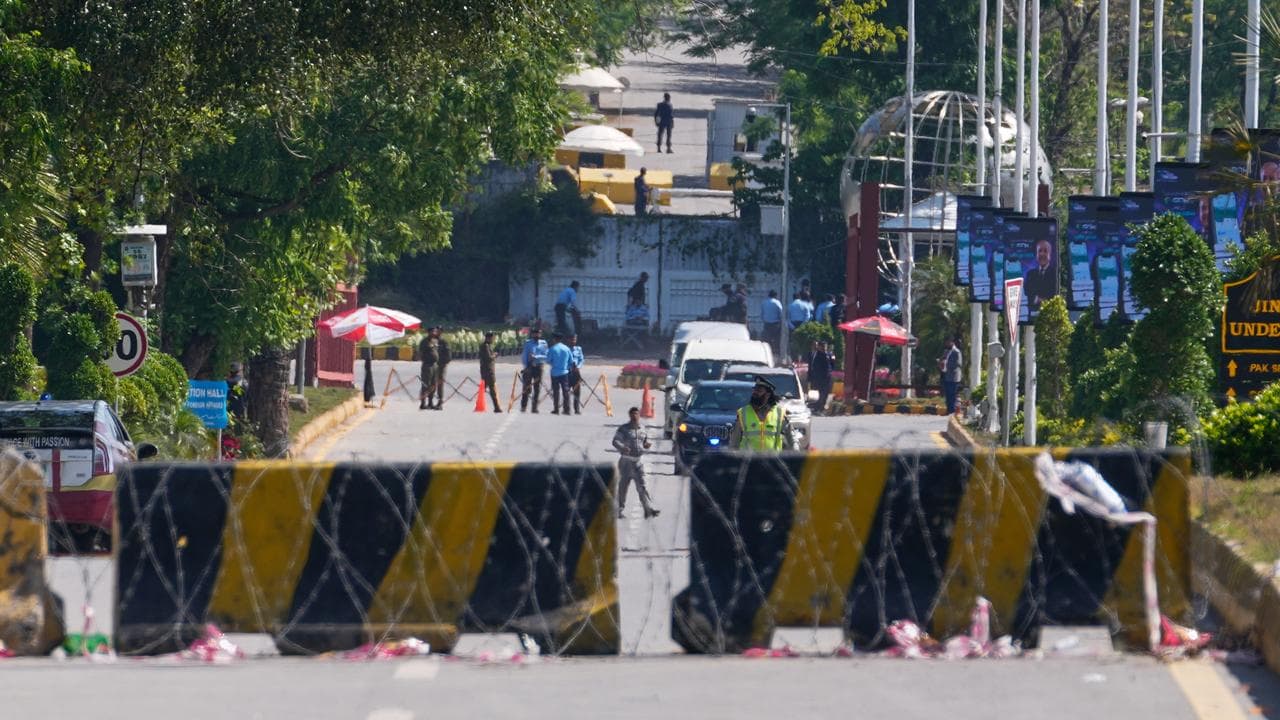 Police officers guard on a barricaded road in Islamabad, Pakistan