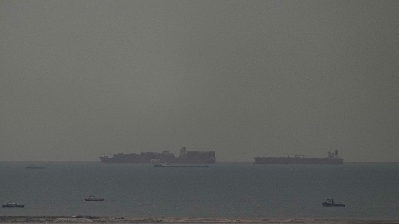 Cargo ships sail through the Arabian Gulf toward the Strait of Hormuz