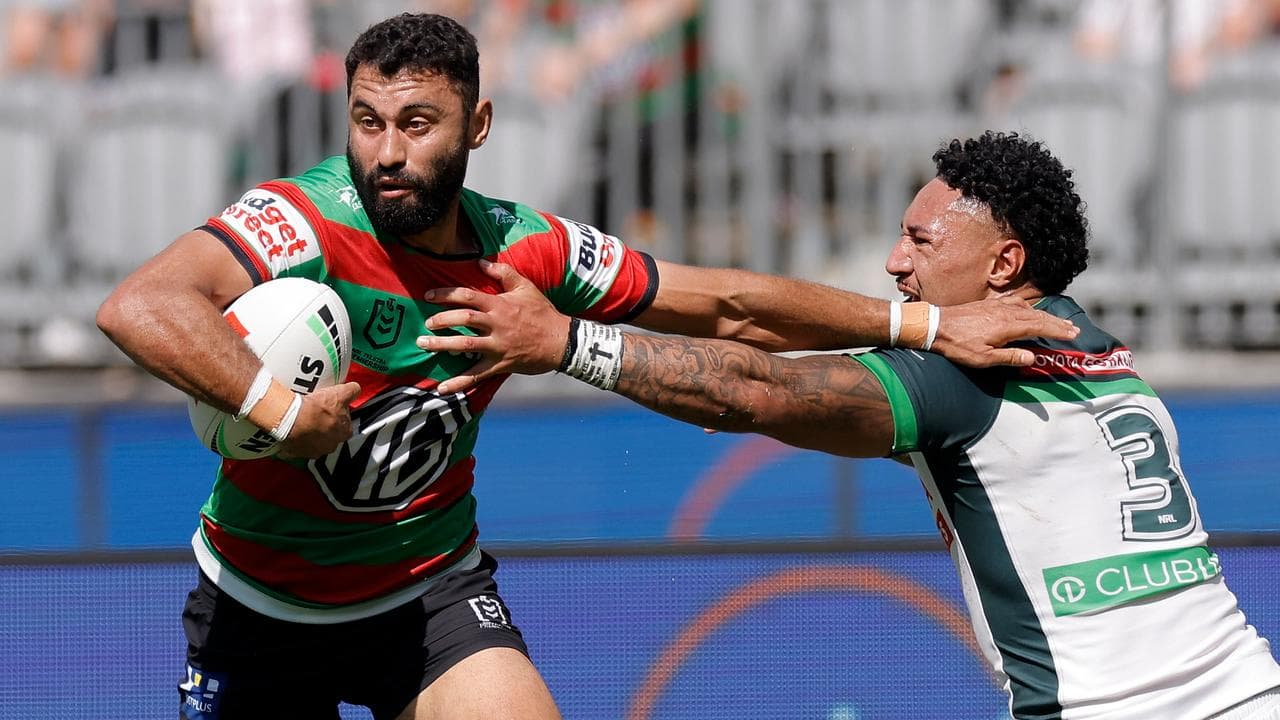 Alex Johnston of the Rabbitohs fends off Simi Sasagi