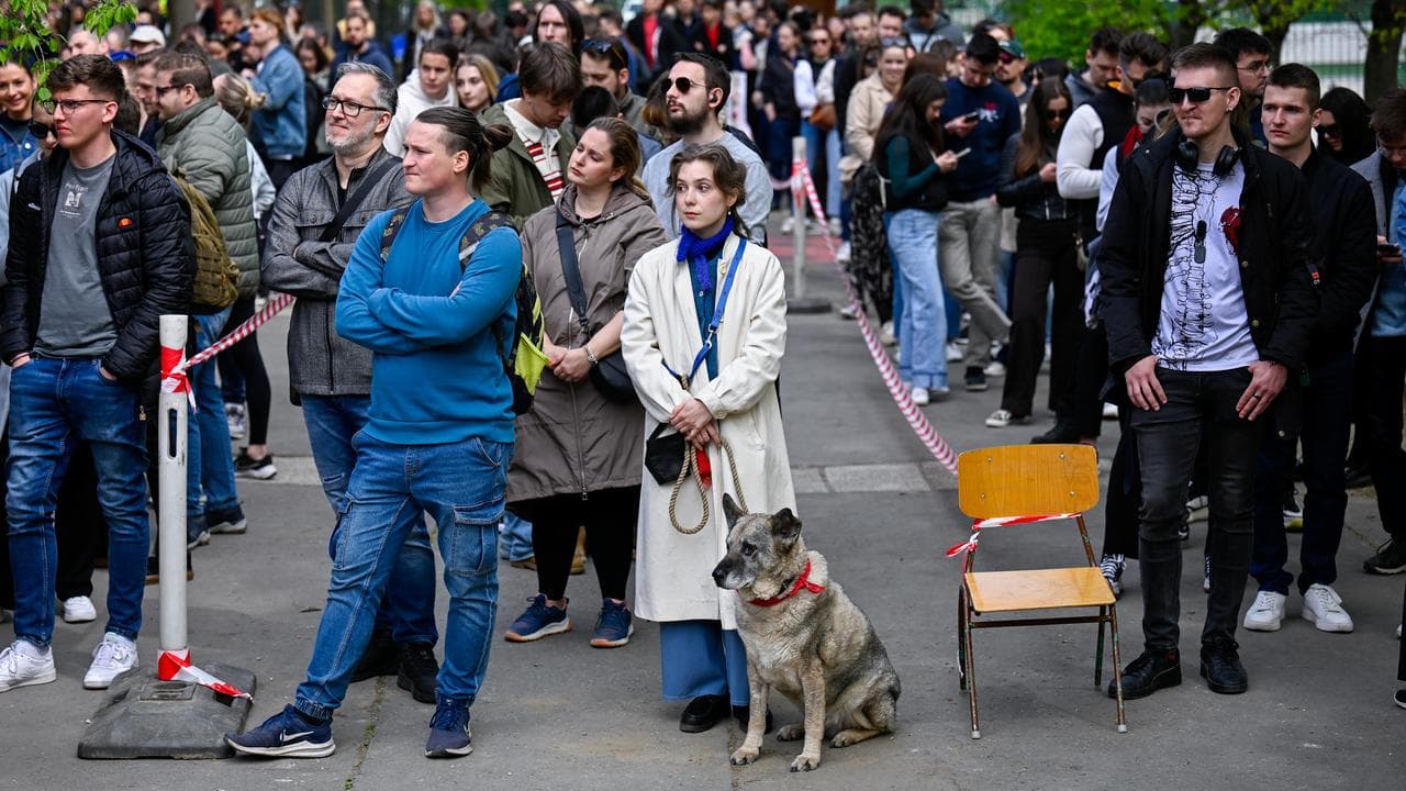 Voters queue up outside a polling station in Budapest