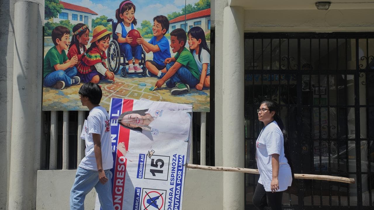 Workers remove campaign signs ahead of the election