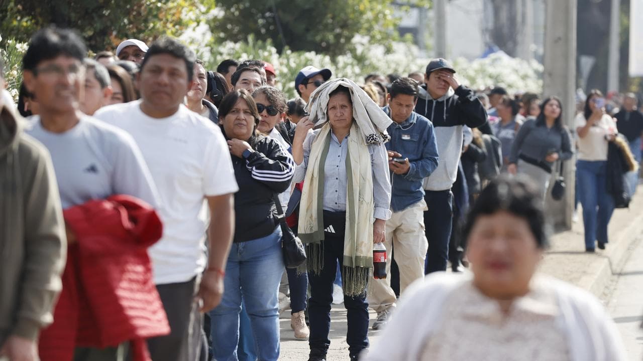 People wait to vote in Peru's presidential election in Santiago, Chile