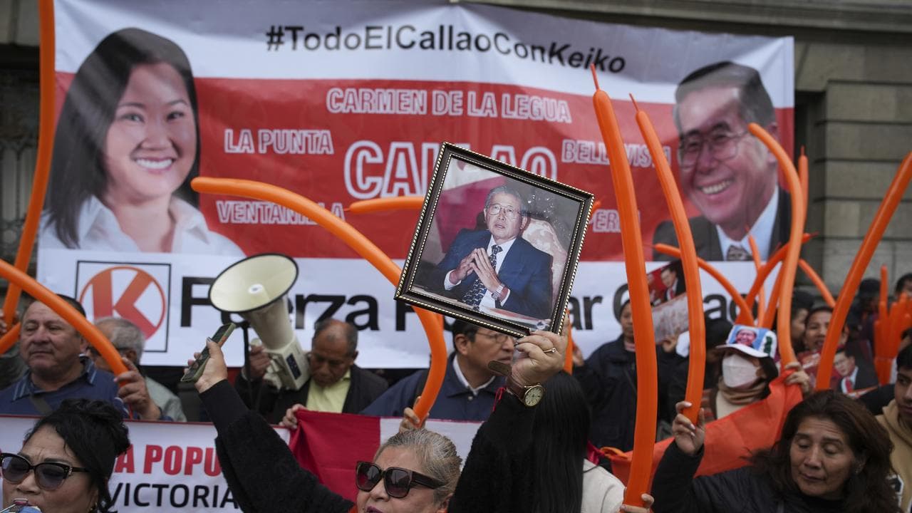 Supporters of former president Alberto Fujimori and his daughter Keiko