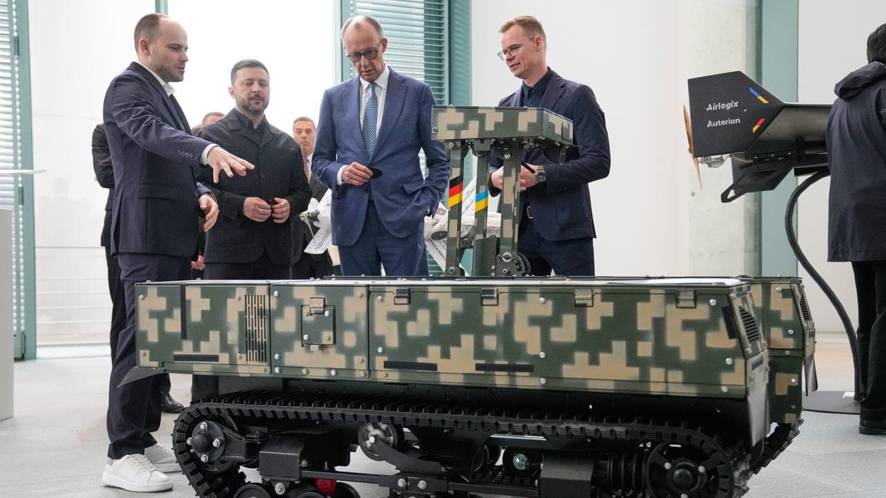 Friedrich Merz and Volodymyr Zelenskiy watch a defence presentation 