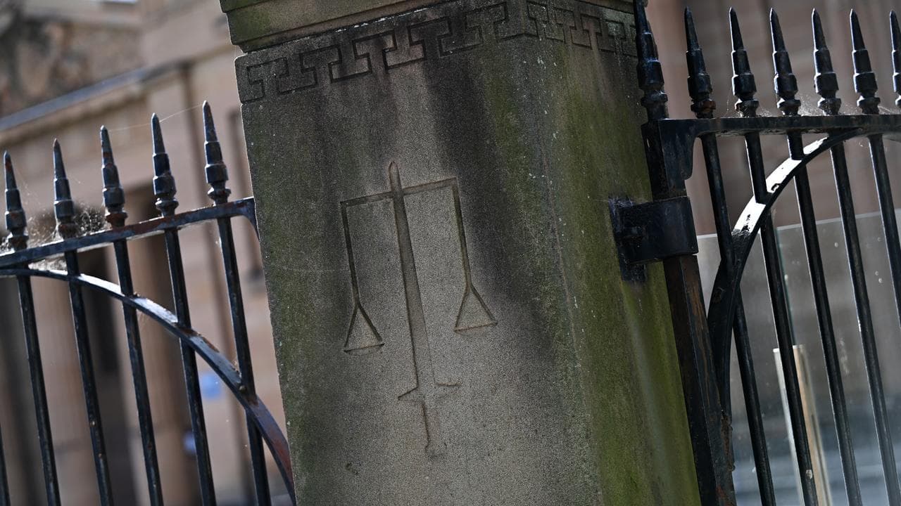 Scales of justice on pillar of court fence (file)
