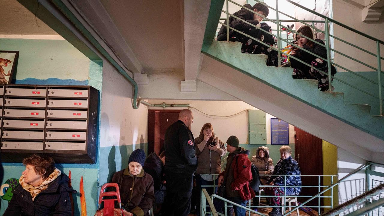 People take shelter in a house damaged after a Russian strike in Kyiv