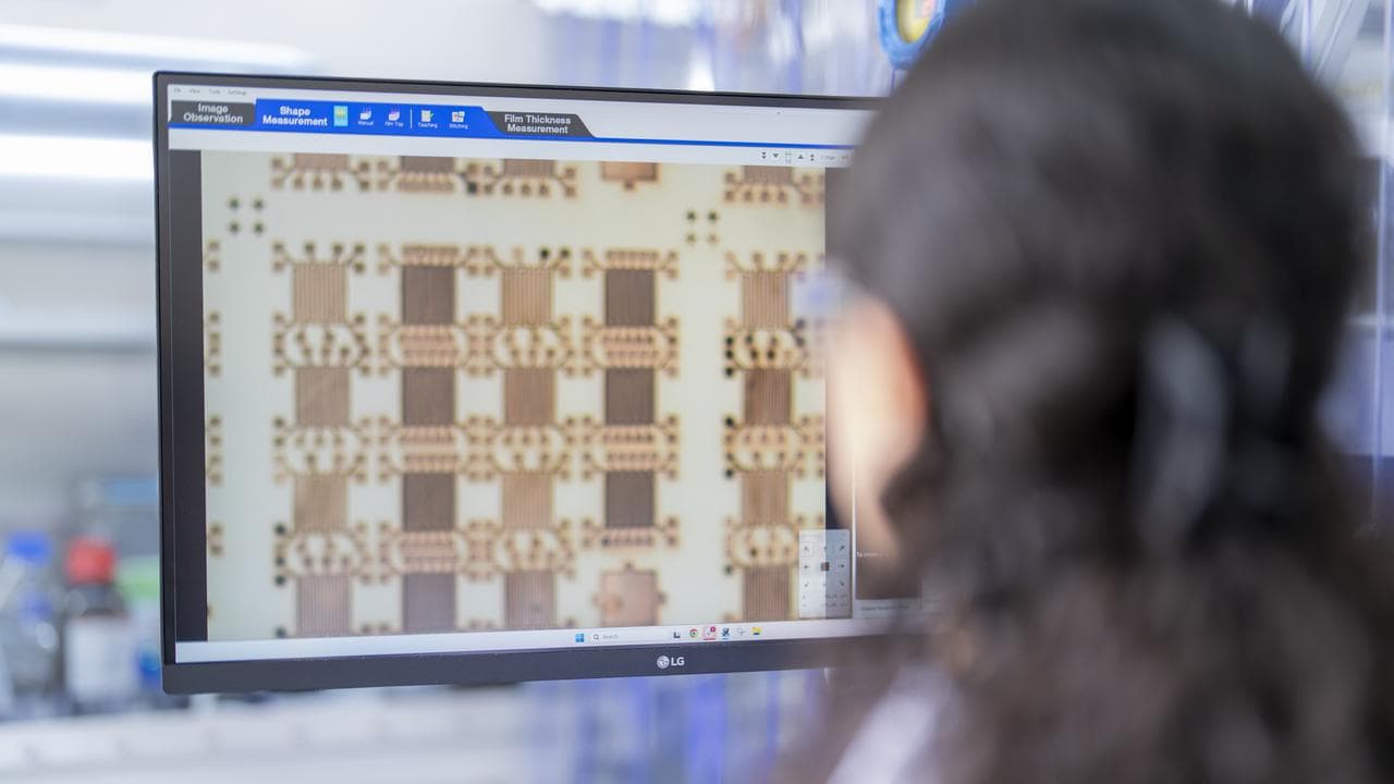 A Syenta employee looks at a computer screen