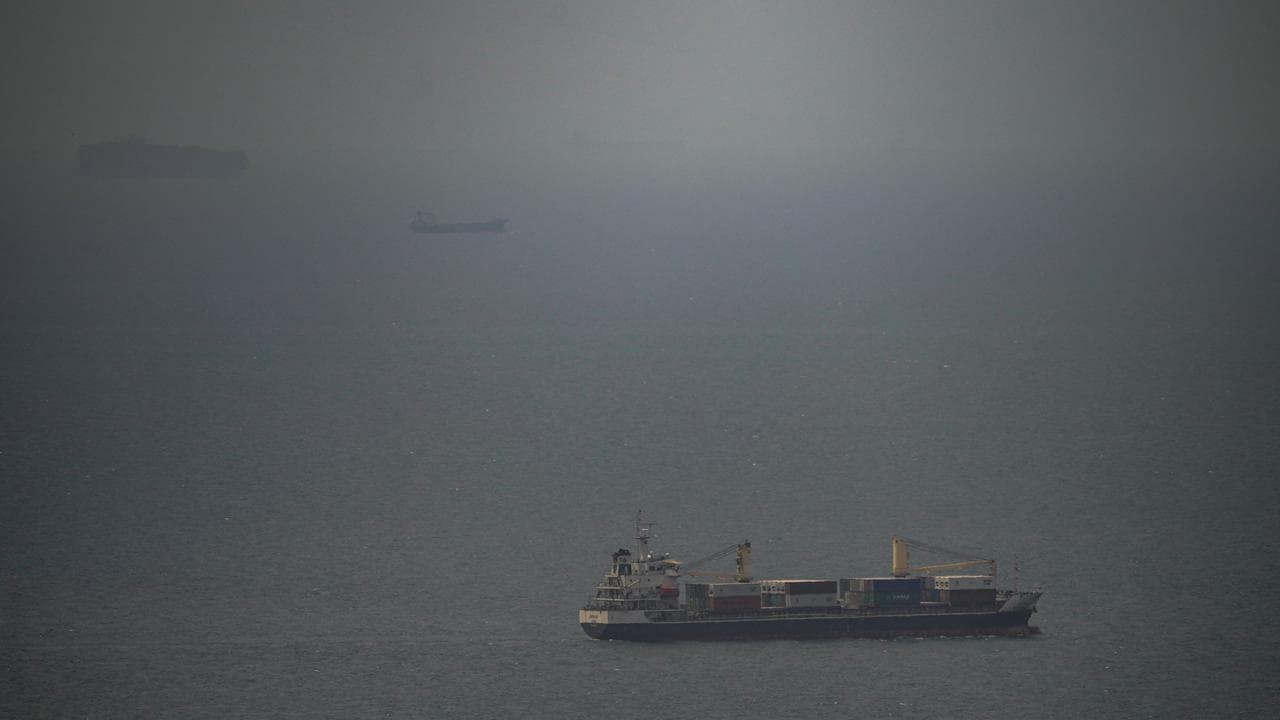 A cargo ship sails in the Persian Gulf toward the Strait of Hormuz