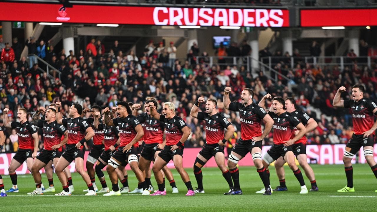 Crusaders players perform a haka.