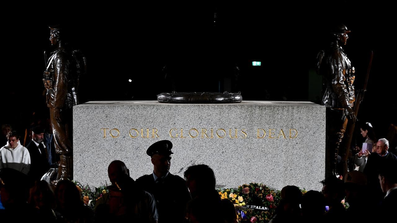 People attend the Anzac Day dawn service at the Cenotaph