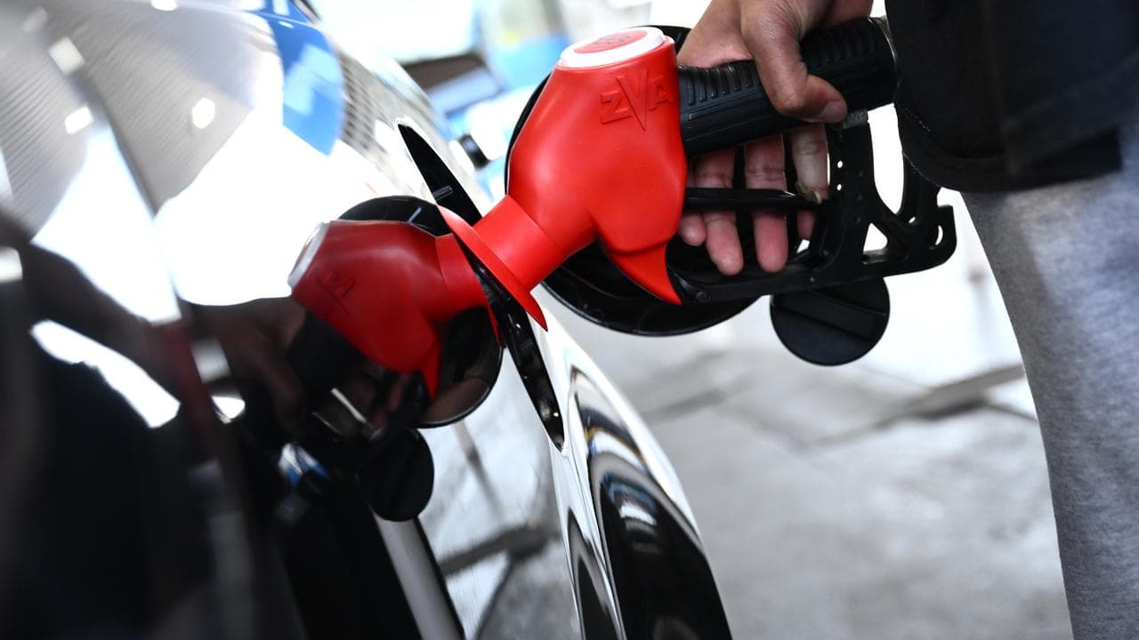 A motorist fills up at a service station in Preston, Melbourne