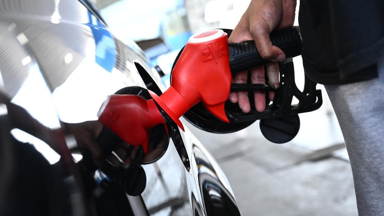 Motorists fill up with petrol at a service station in Melbourne