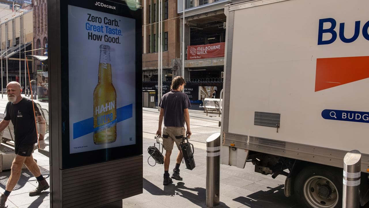 Workers are seen along Bourke Street, in Melbourne