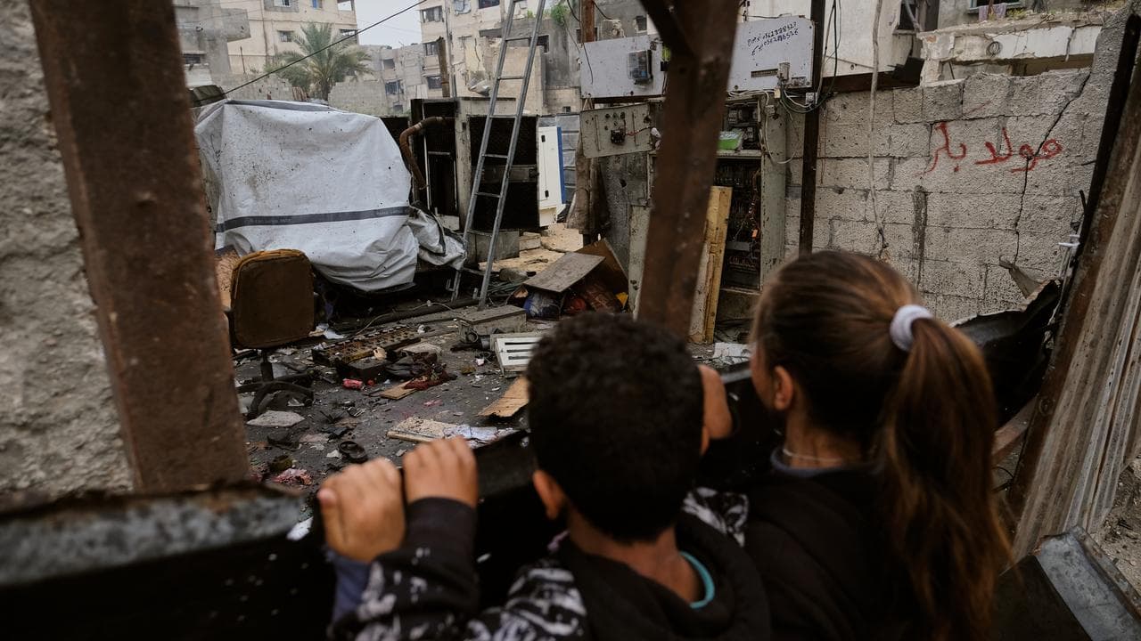 Children inspect the damage after an Israeli air strike in Gaza City