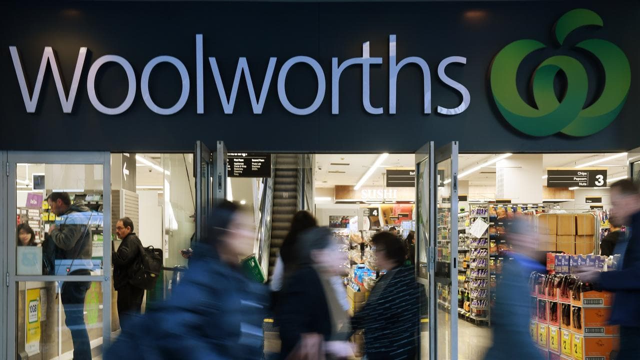 Shoppers walk past a Woolworths store in Sydney (file image)