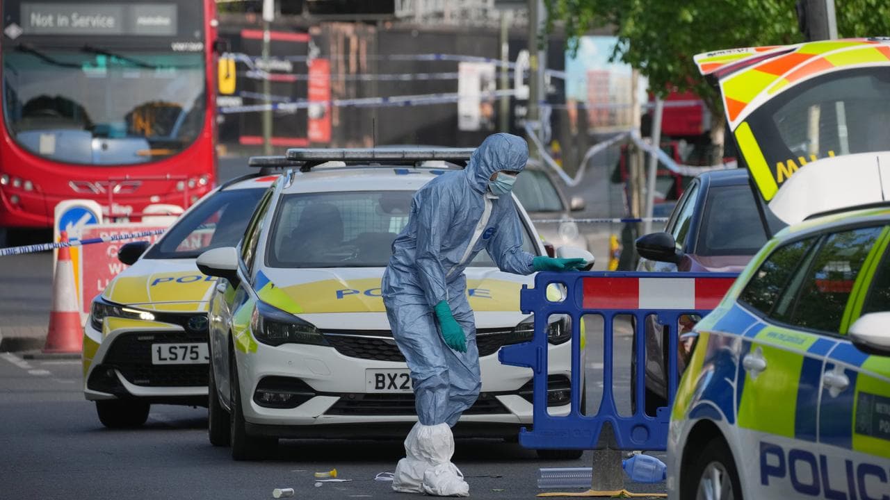 A forensic officer after two people were stabbed in Golders Green