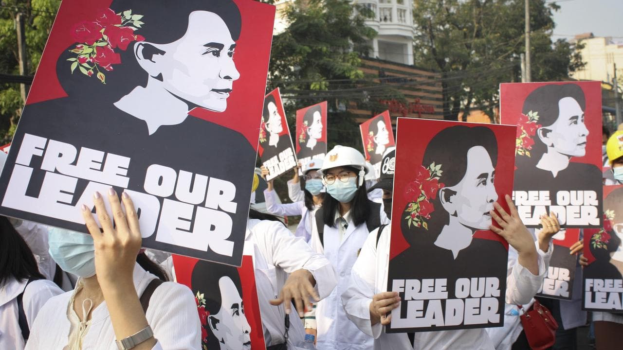 Students display images of deposed Myanmar leader Aung San Suu Kyi