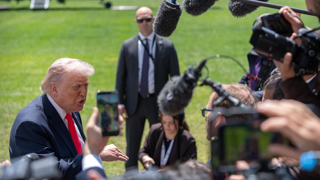 Donald Trump speaks with reporters near the White House