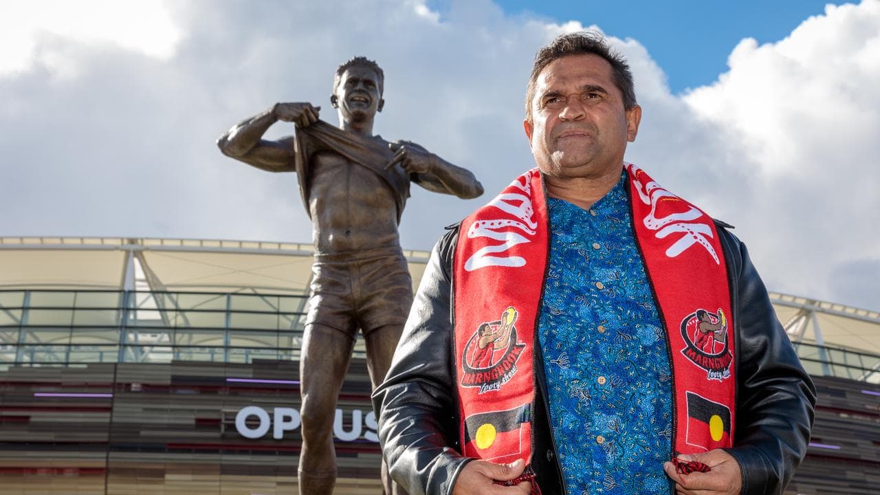Nicky Winmar poses in front of his statue in Perth (file)