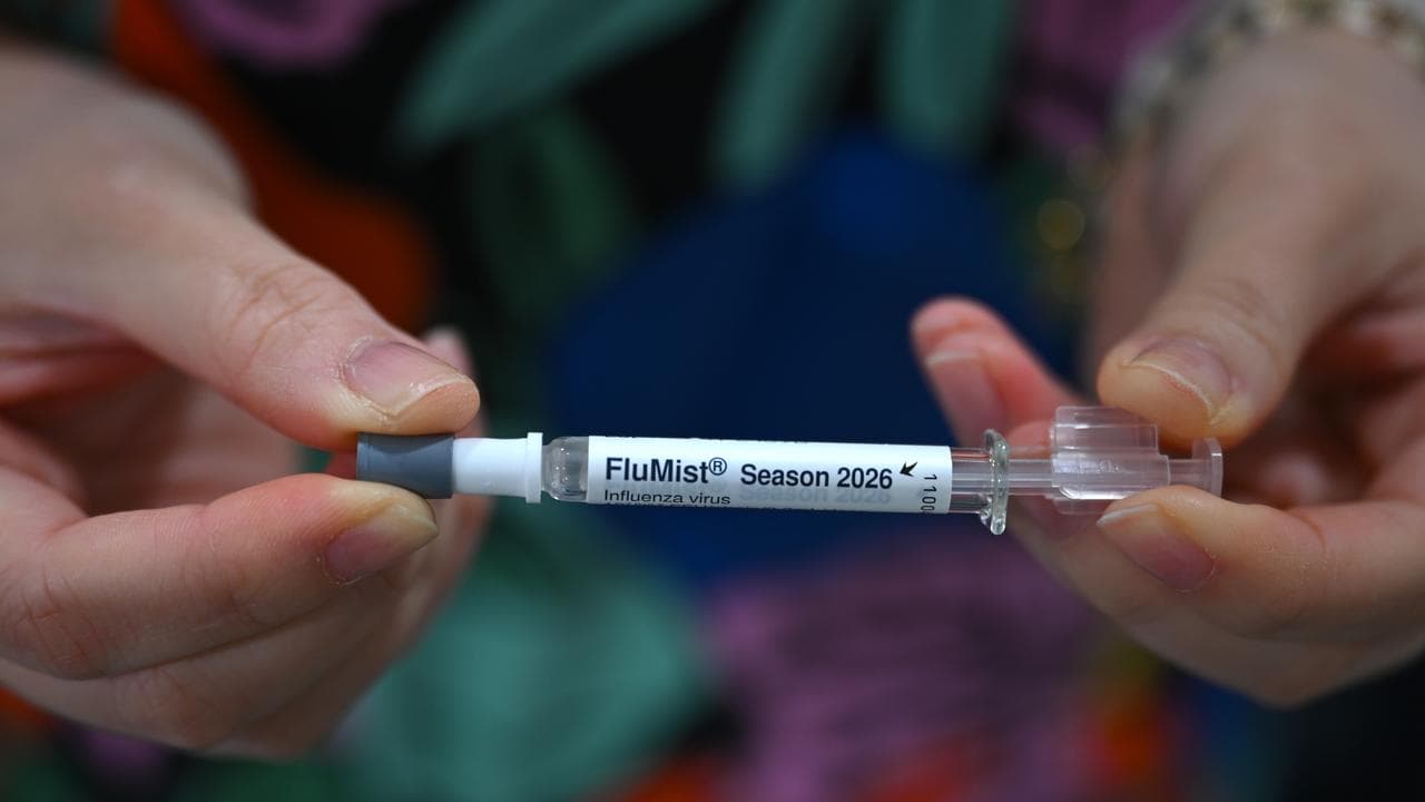 A nurse holds the FluMist needle-less flu vaccine