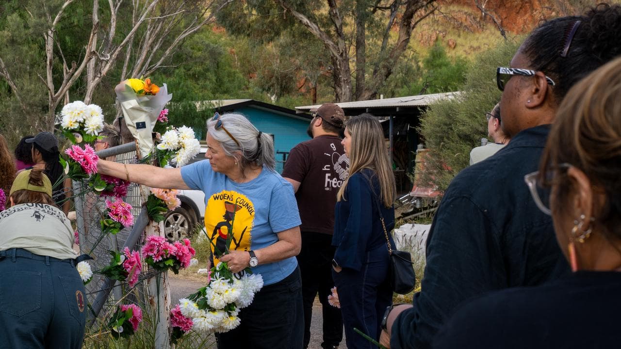 Alice Springs residents place flowers at the town camp.
