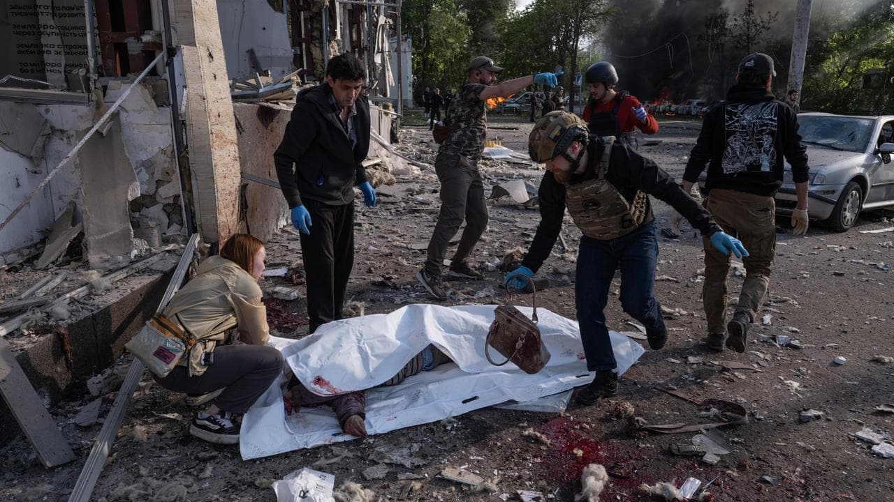 People cover bodies of civilians killed in Russian attacks in Ukraine