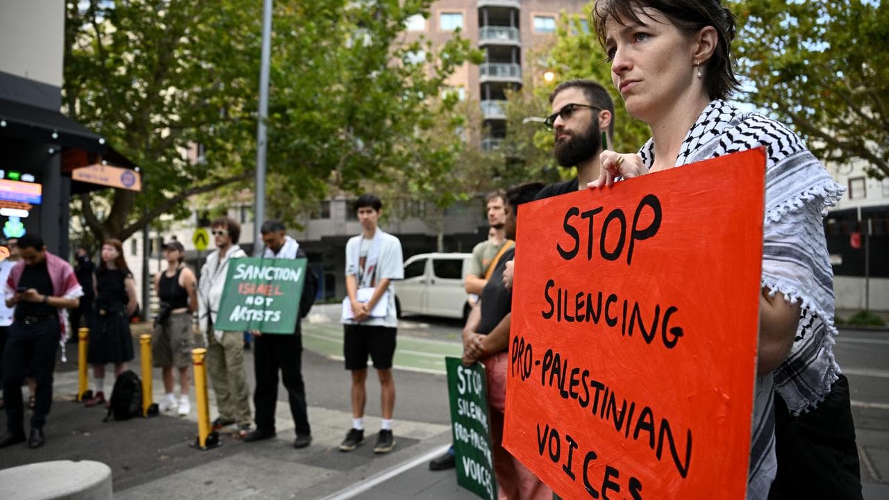 Protesters hold signs at a protest